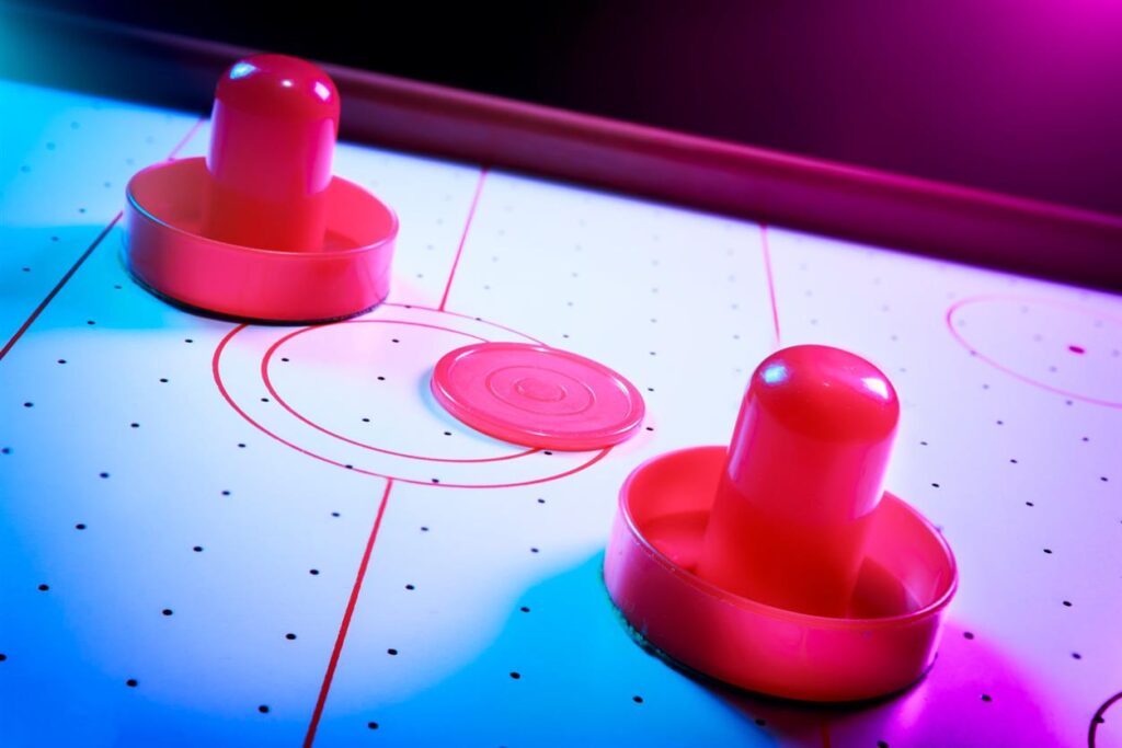Air hockey table with dramatic lighting on a dark background
